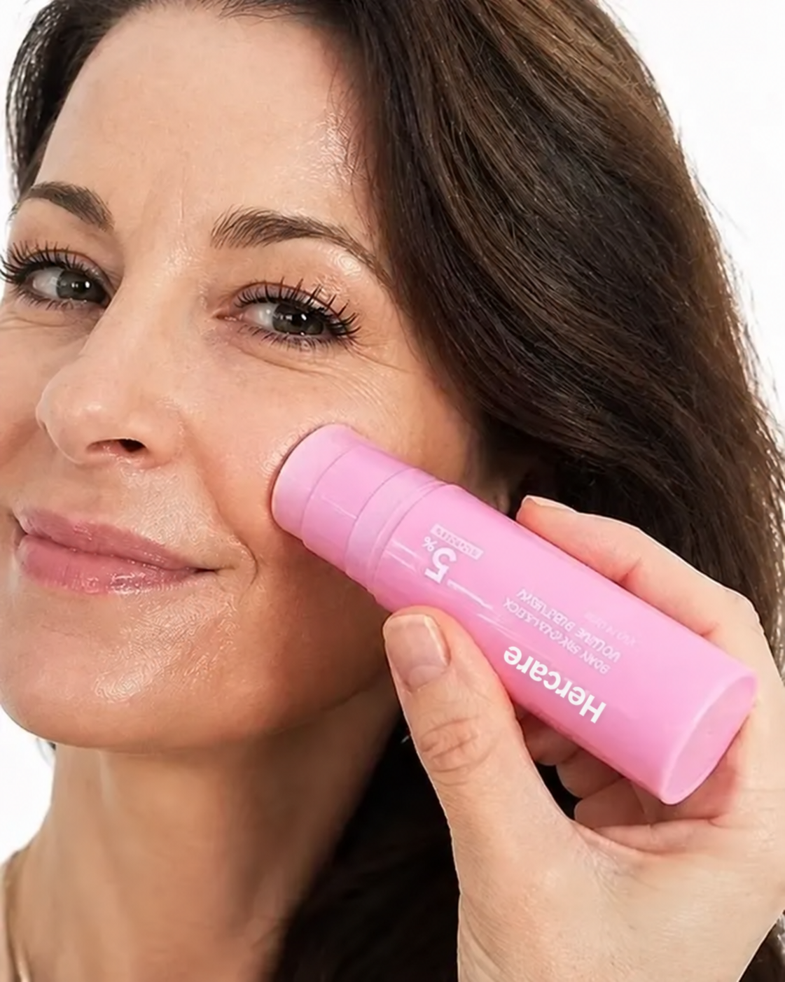 Woman applying Hercare balm to her cheek